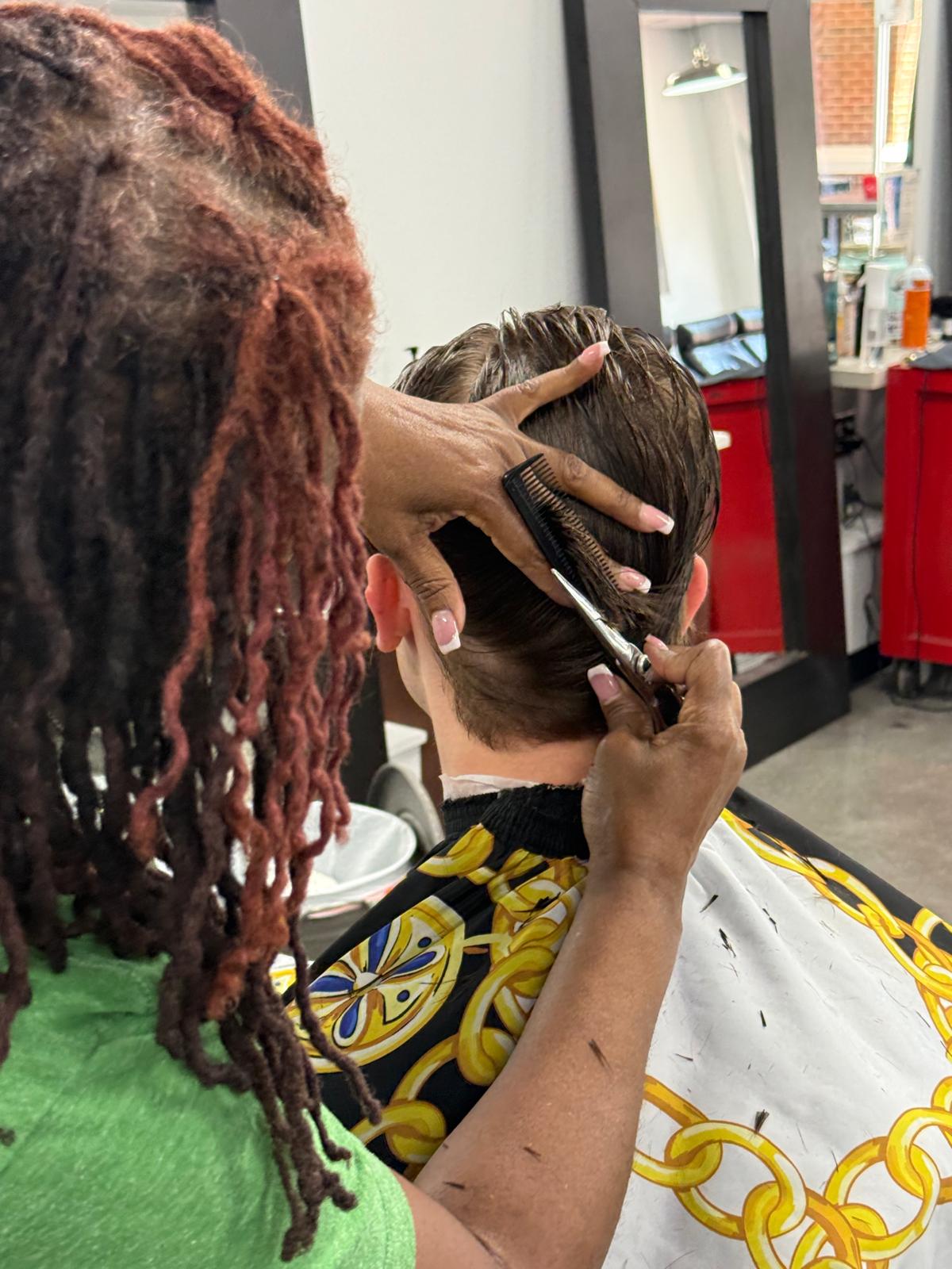 Barber cutting a young client’s hair
